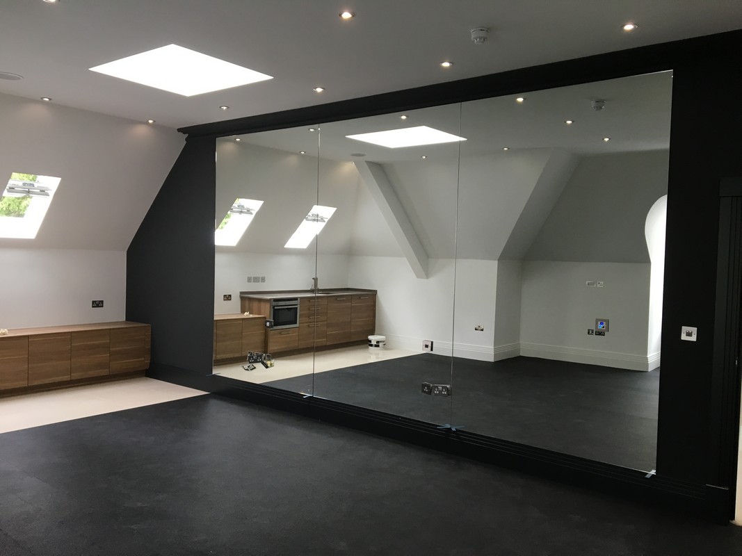 Frameless glass wall dividing loft conversion in Belgravia
