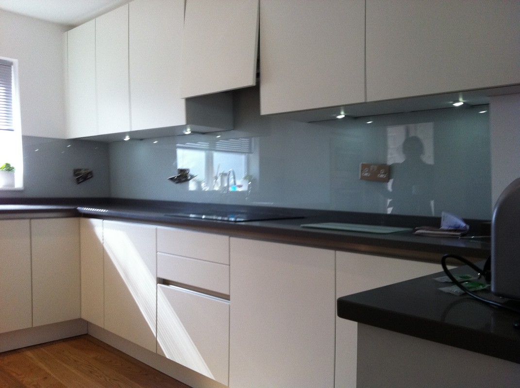Grey glass kitchen splashback with LED lighting in Belgravia