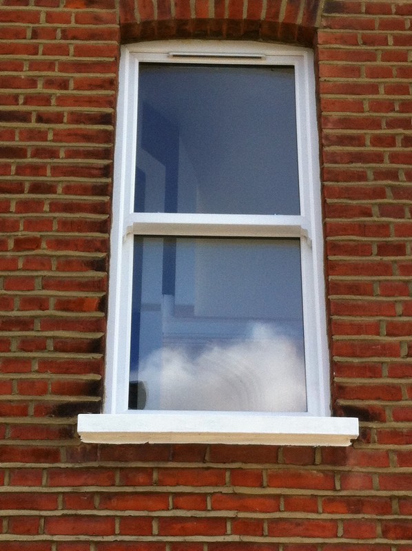 uPVC sash window on Victorian red brick house in Belgravia